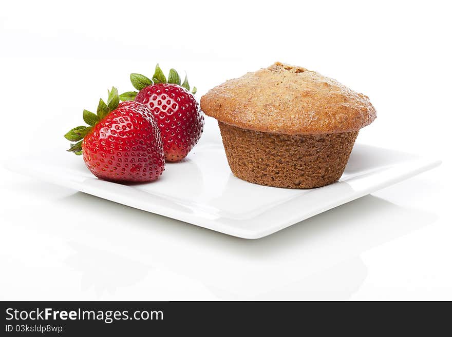 A fresh bran muffin against a white background