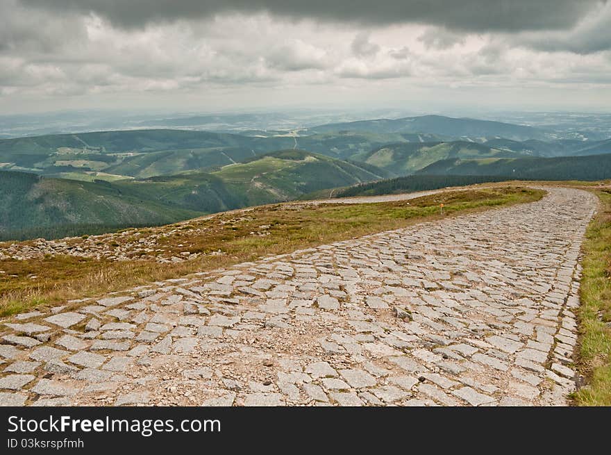 Rock climbing route and view of the mountains before the storm