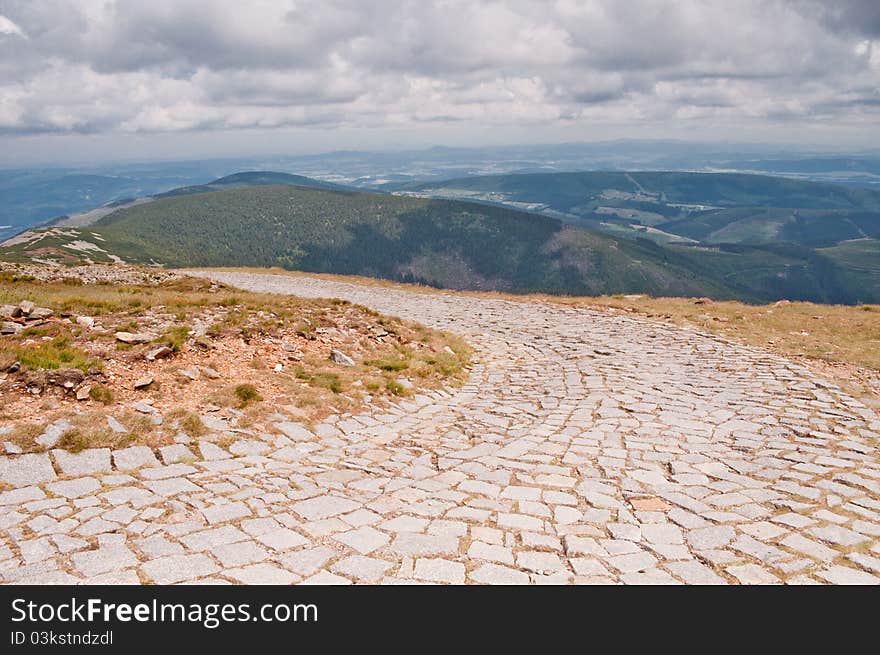 Rock climbing route and view of the mountains before the storm