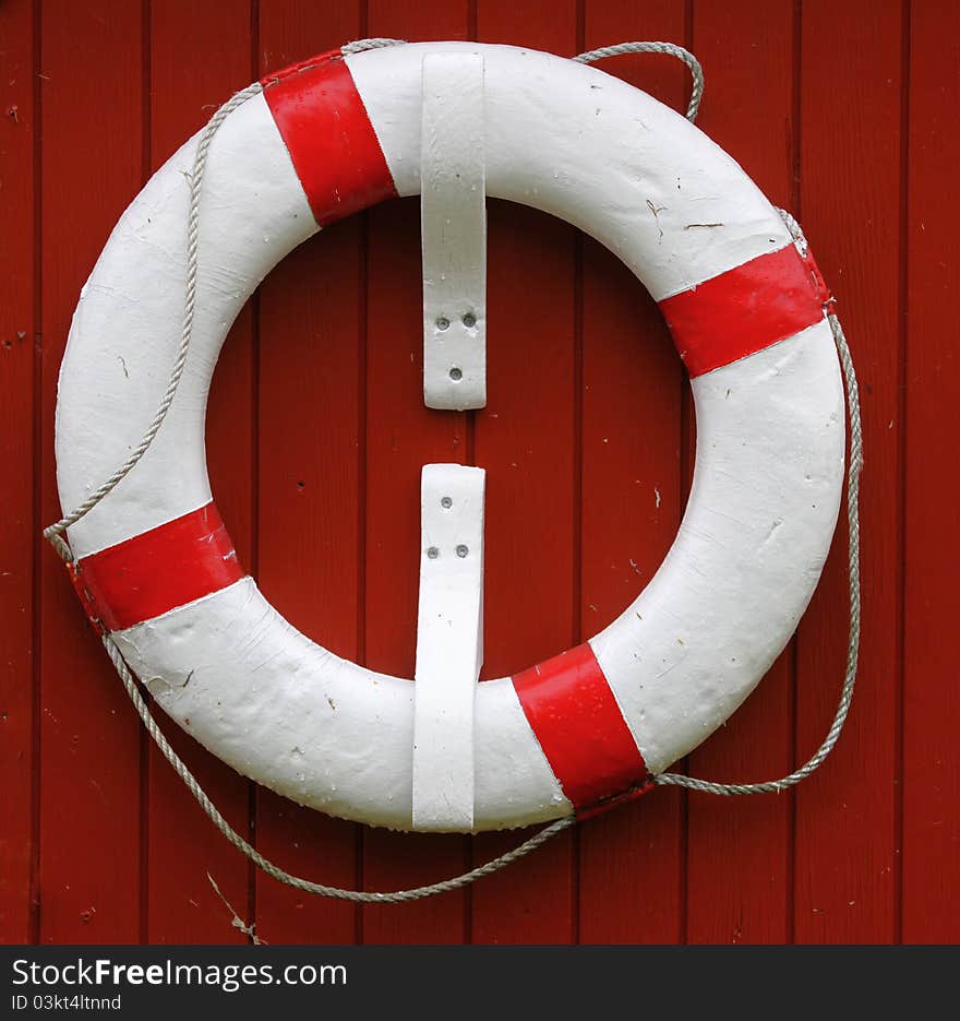 Lifejacket on a red wall