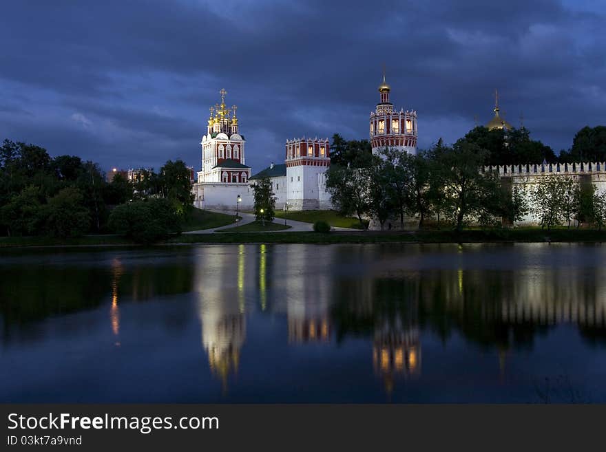 Little lake reflected church in the night in the center of moscow