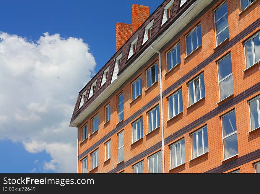 Built house of brick against the blue sky. Built house of brick against the blue sky