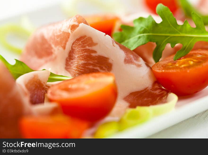 Sliced coppa with cherry tomatoes