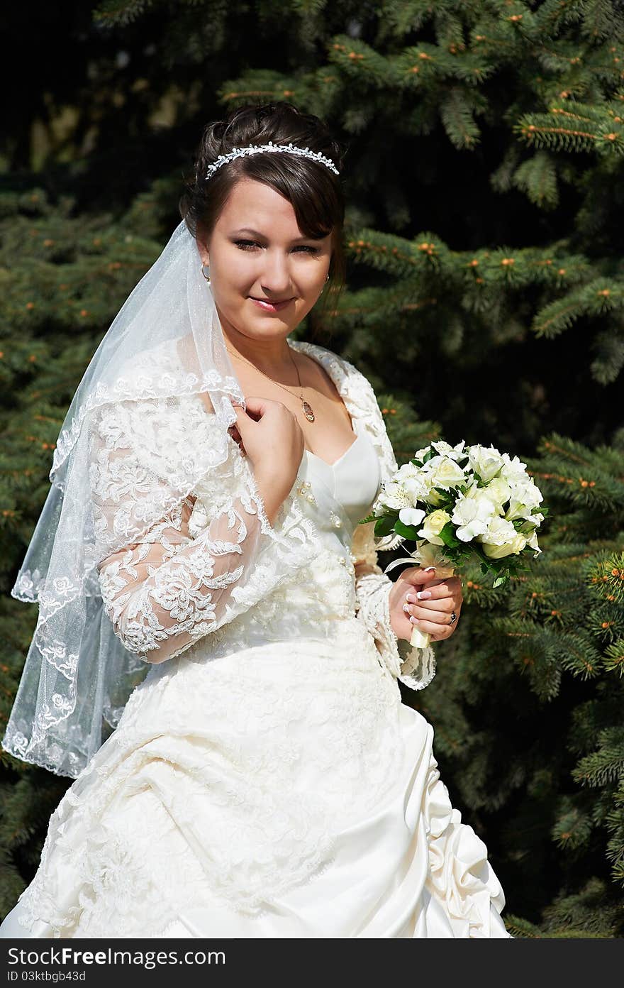 Happy Bride On Background Of Green Spruce