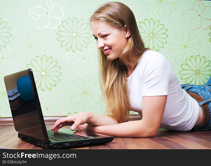 Young woman on the floor working with laptop. Young woman on the floor working with laptop