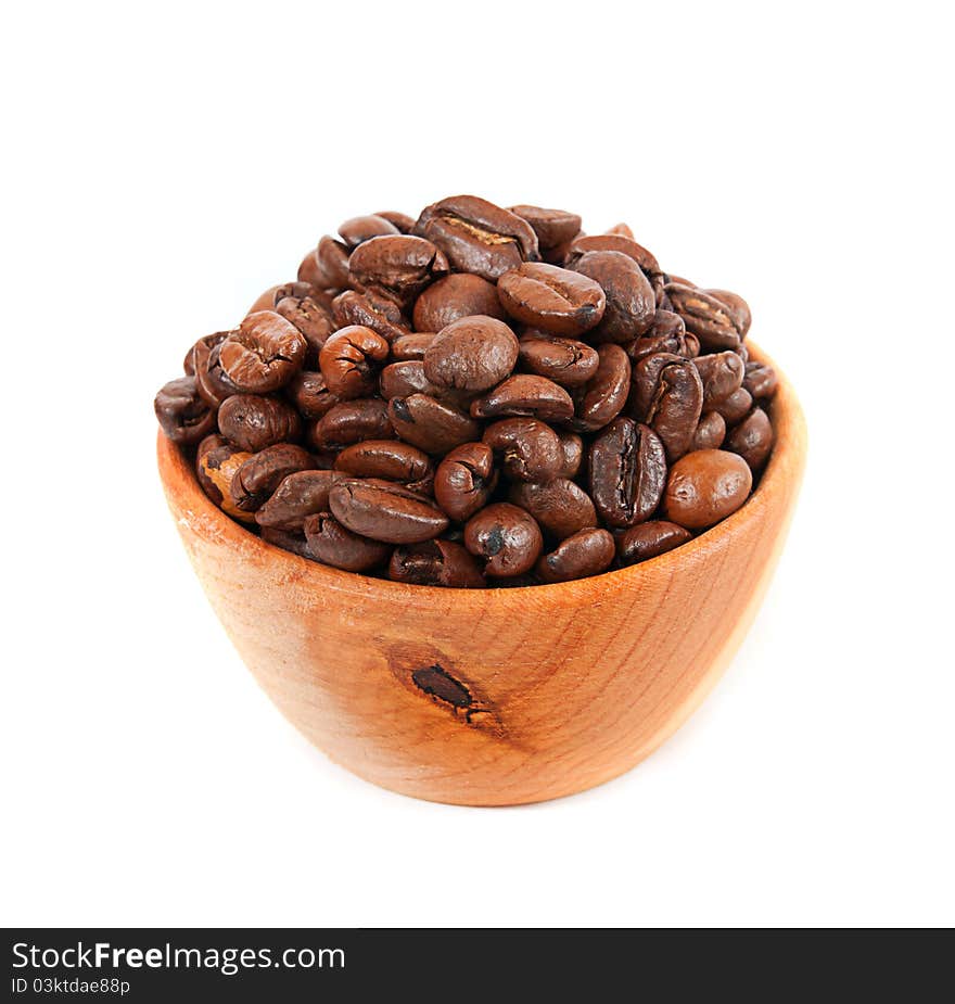 Coffee beans in a wooden platter isolated on a white background