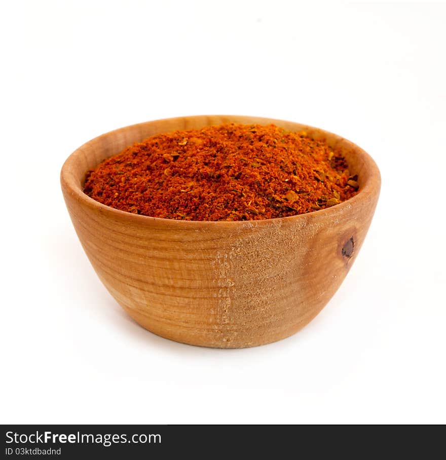 Spices in a wooden platter isolated on a white background