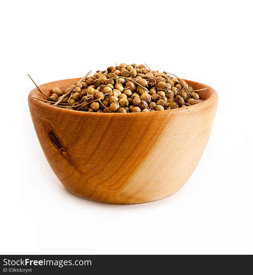 Spices in a wooden platter isolated on a white background