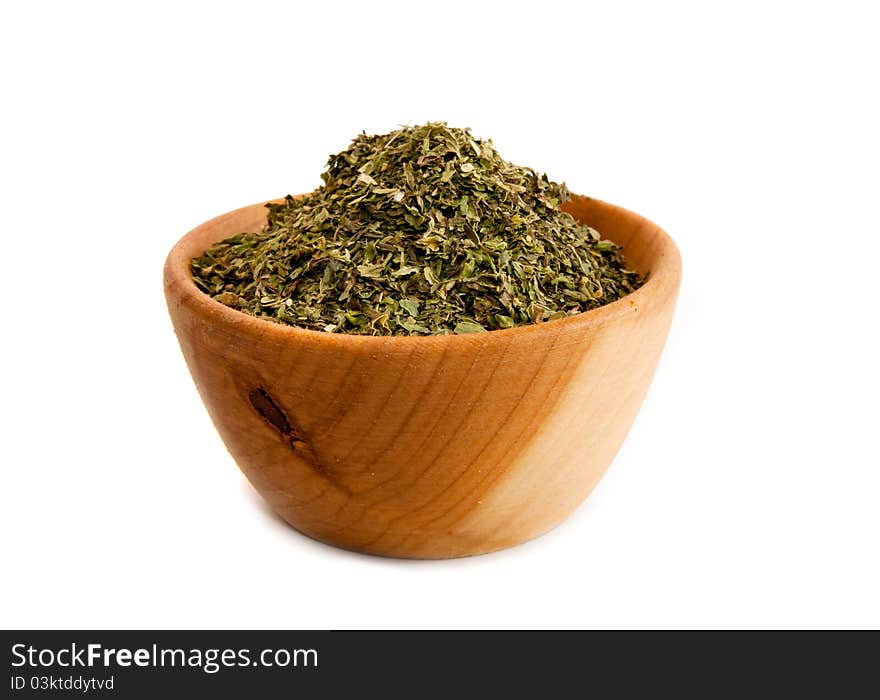 Spices in a wooden platter isolated on a white background