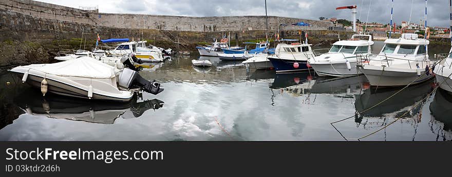 A nautical port with several yachts and fishing boats in Comillas (Spain) in the bay of Biscay.