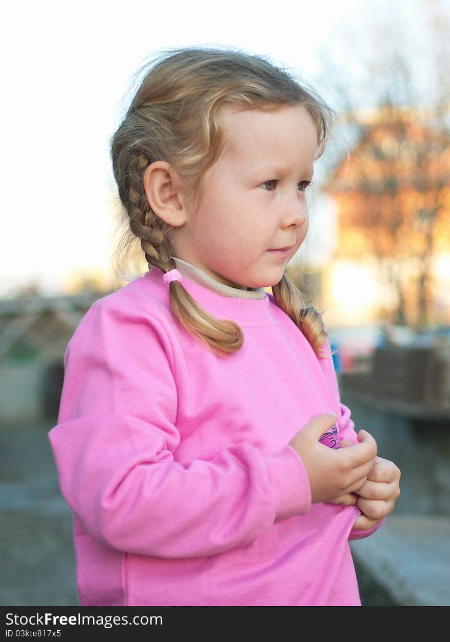 The little serenity girl in pink on abstract background. Shallow DOF