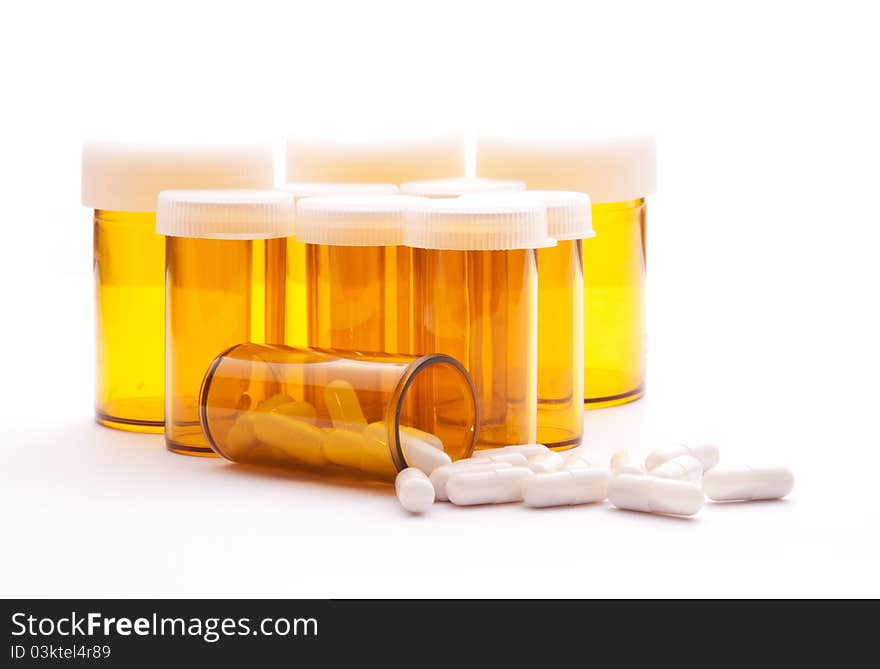 Pill Containers with White capsules inside, all on a bright white background