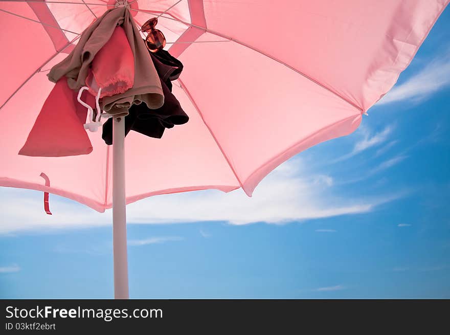 Beach umbrella with clothes attacked