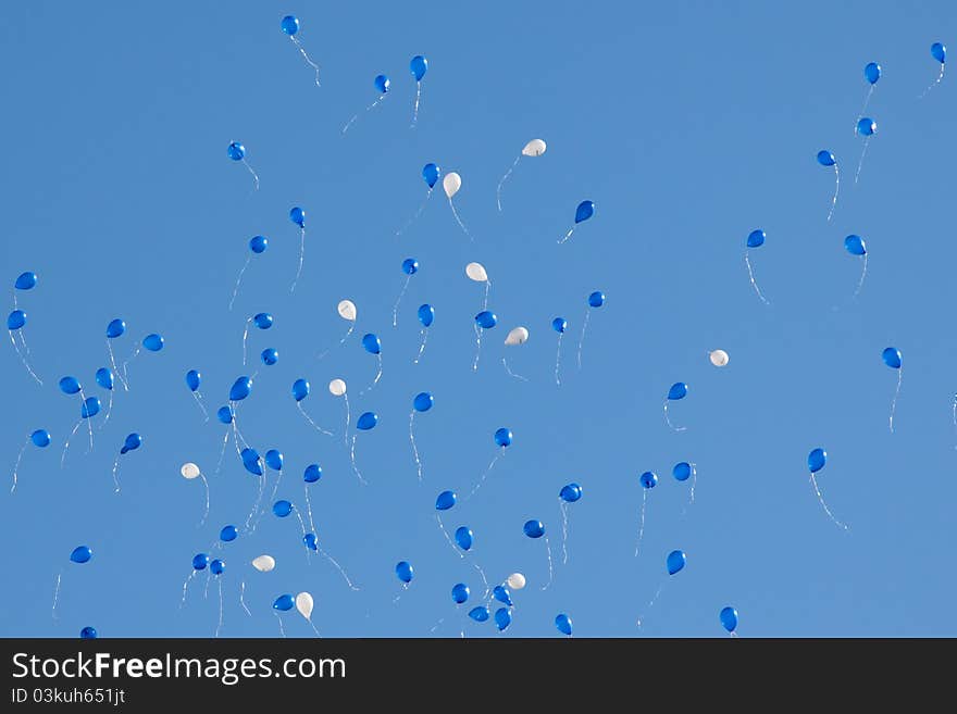 Blue and white balloons in blue sky