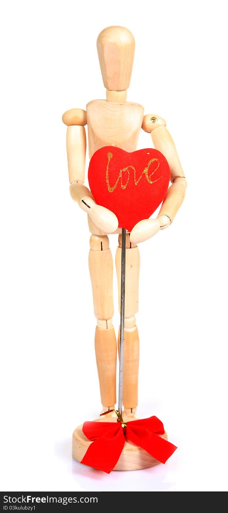 Wooden mannequin holding red heart over white background. Wooden mannequin holding red heart over white background.