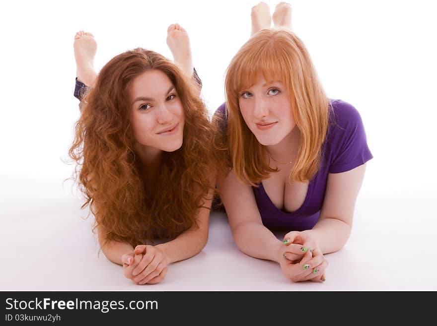 Two friends lying side by side on the floor