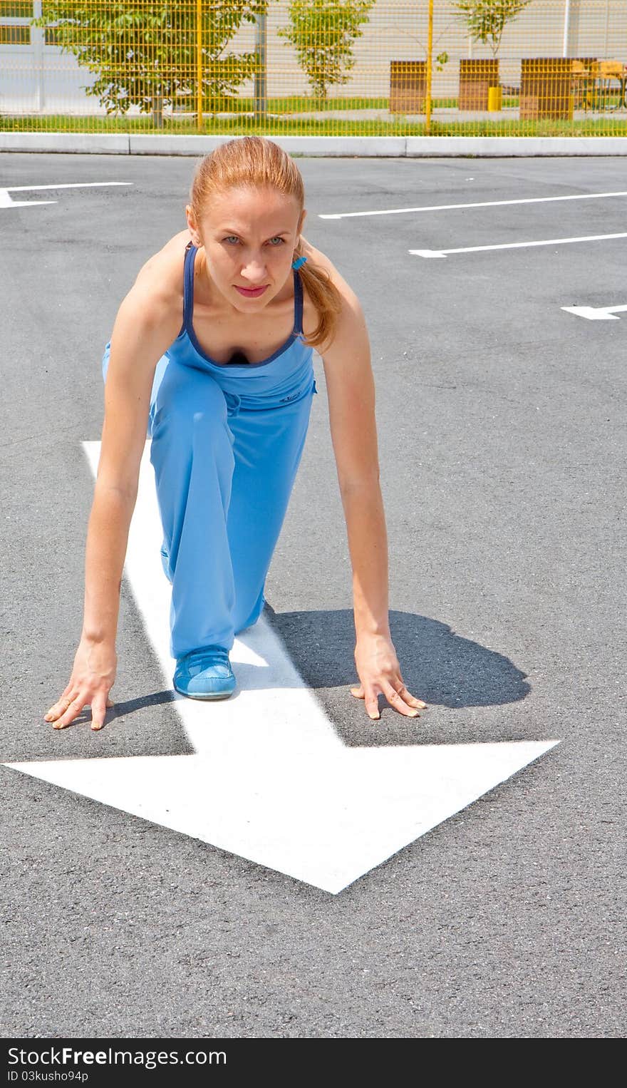 Athletic Woman In Start Position On Track