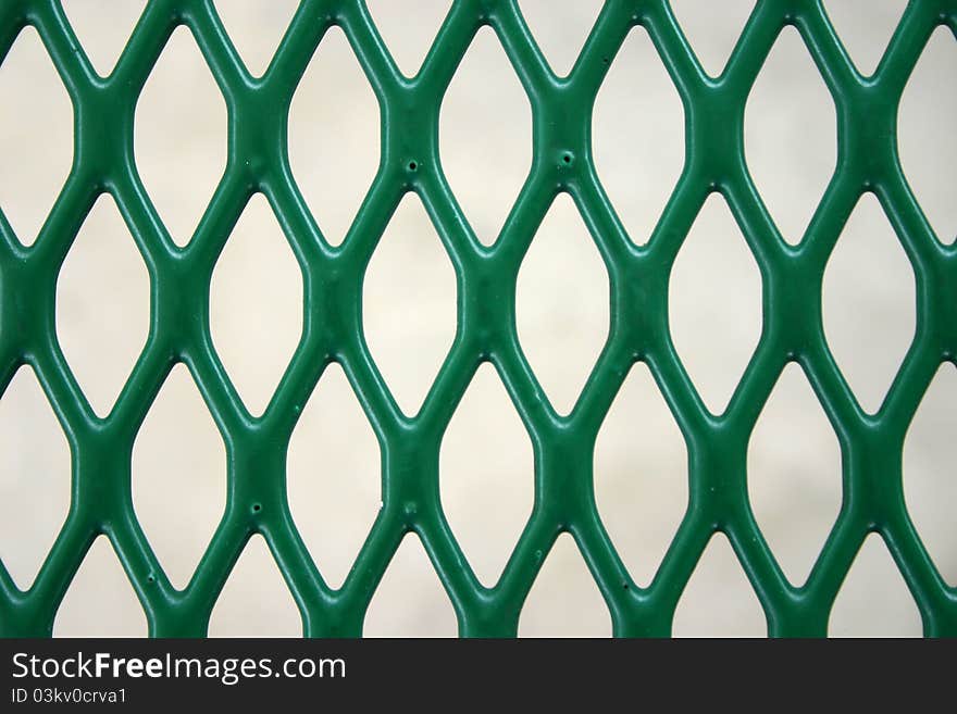 The grid of a green picnic table top. The grid of a green picnic table top