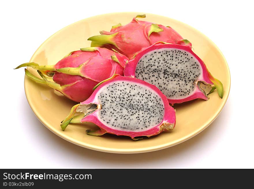 Horizontal shot cut and whole dragon fruit on plate with isolated on white. Horizontal shot cut and whole dragon fruit on plate with isolated on white