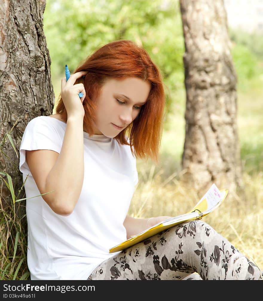 Girl doing homework at outdoor.