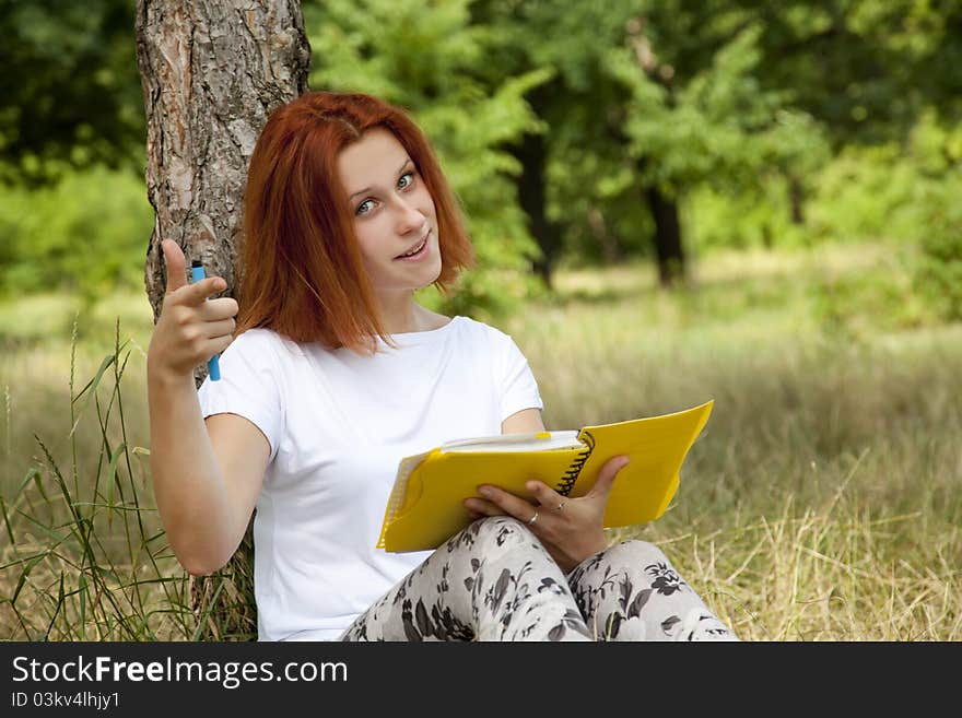 Girl doing homework at outdoor.