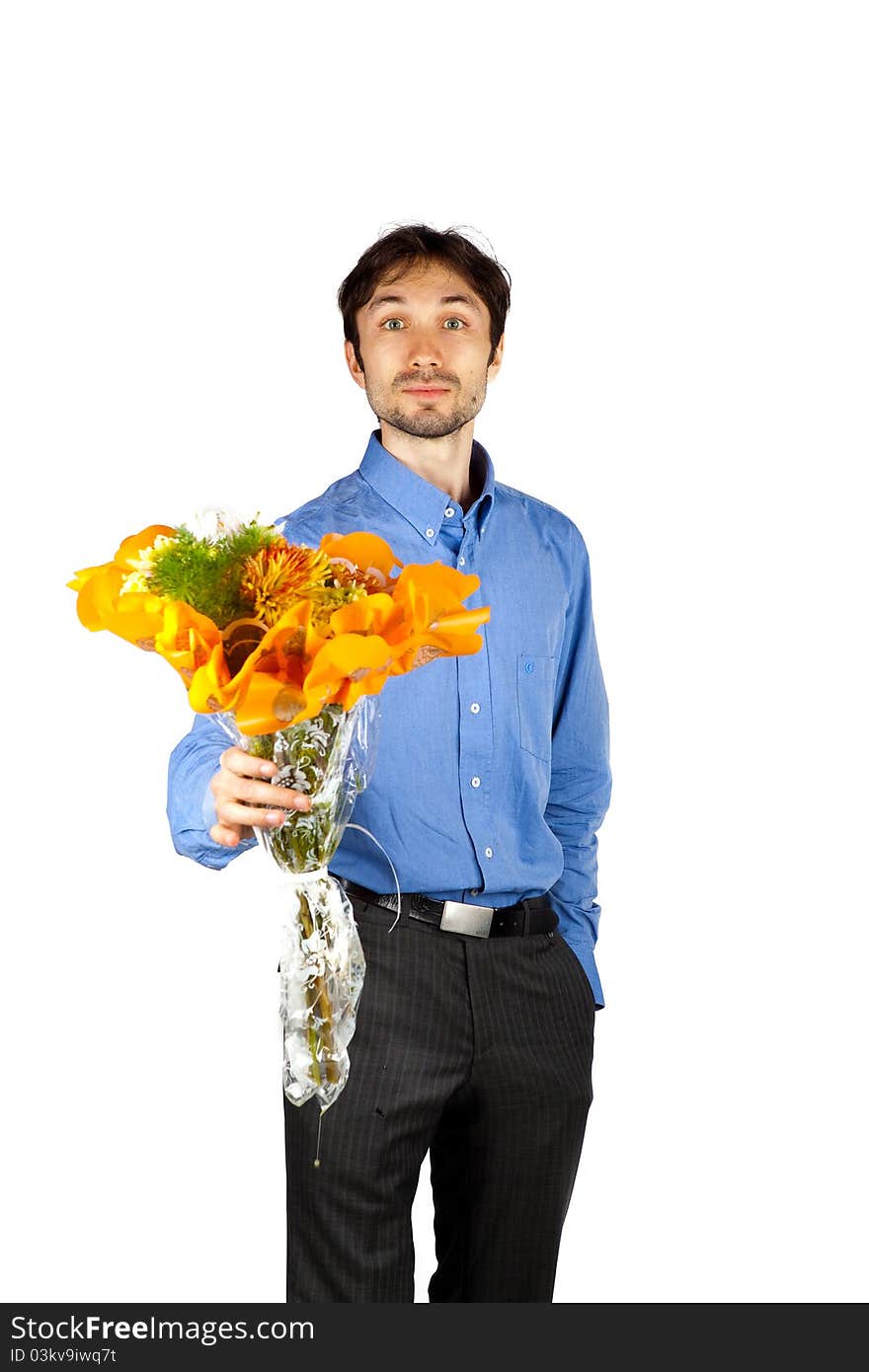 Nice man in a blue shirt with orange bristles standing with a bunch of flowers and smiling