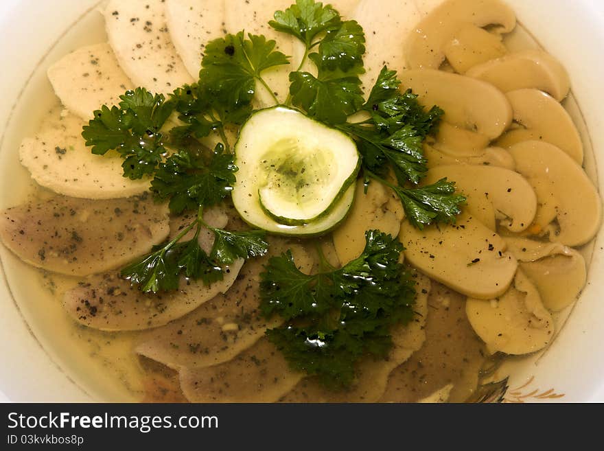 Aspic from meat decorated with cucumber and parsley