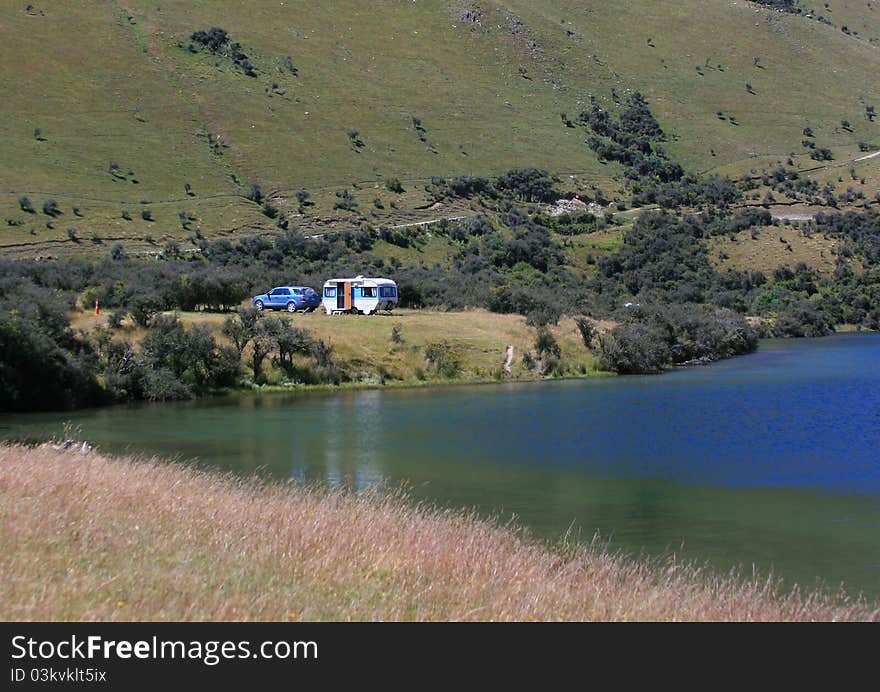 A family caravan camping beside Lake Moke, New Zealand. A family caravan camping beside Lake Moke, New Zealand.