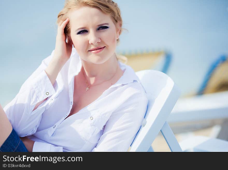 Beautiful woman sitting in chaise