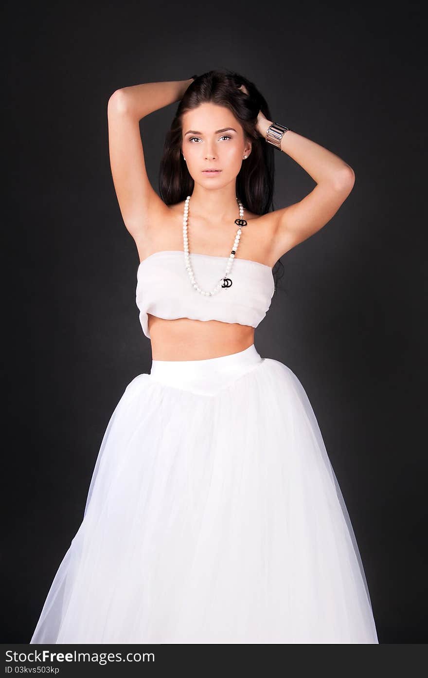 Young woman in white outfit isolated on black