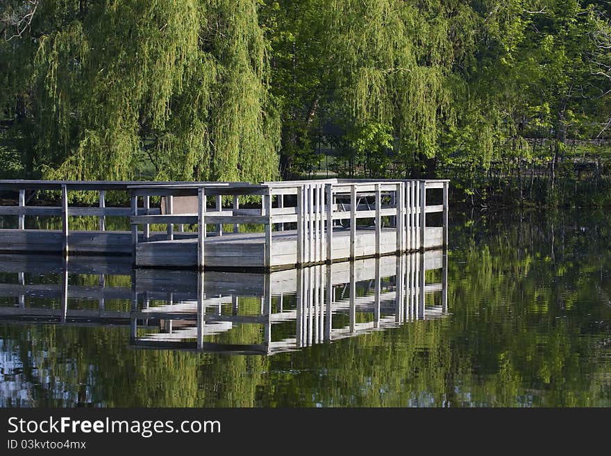 Boat dock sits in the middle of a pond.