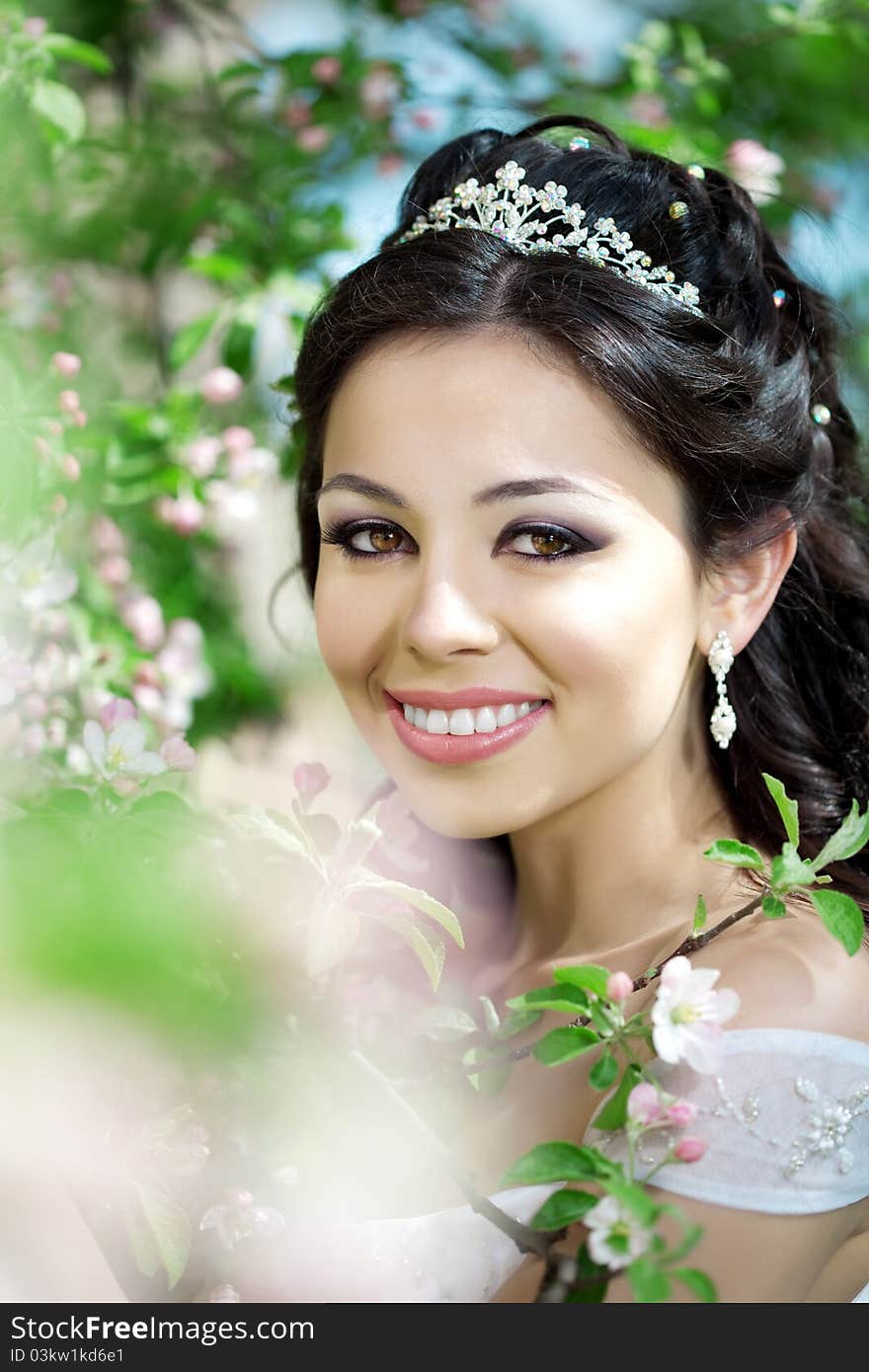 Beautiful bride in a blossoming garden