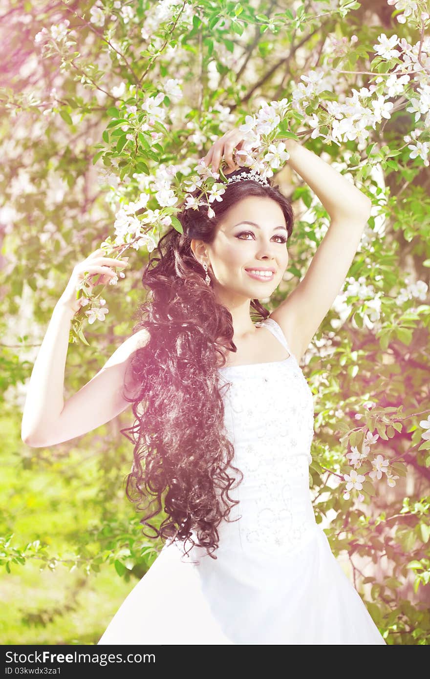 Beautiful bride in a blossoming garden