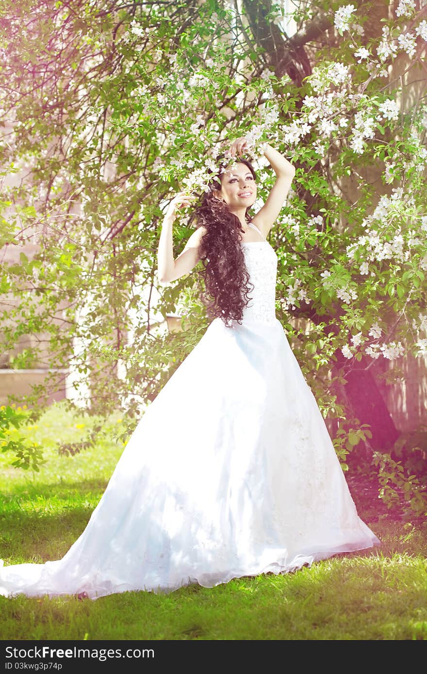 Beautiful bride in a blossoming garden