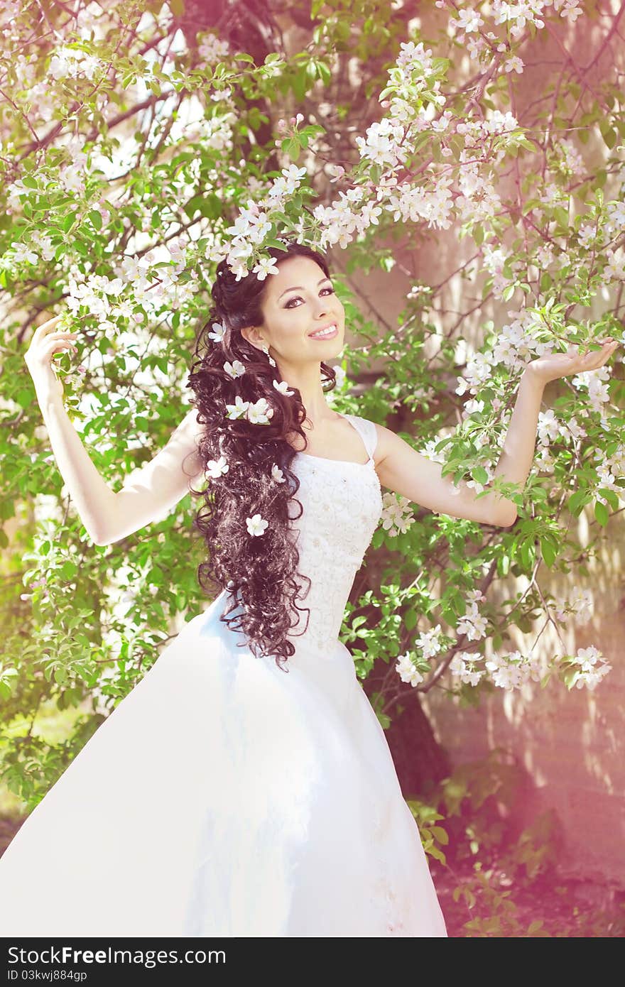 Beautiful bride in a blossoming garden