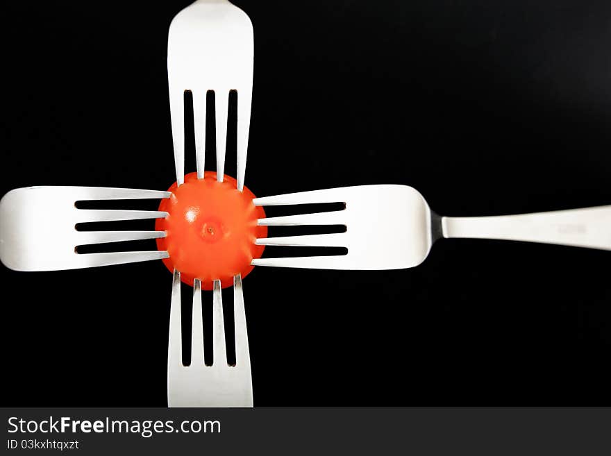 Red Vegetable with forks on black background