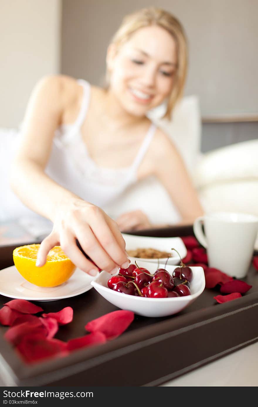 Happy woman having healthy breakfast at the bed. Happy woman having healthy breakfast at the bed