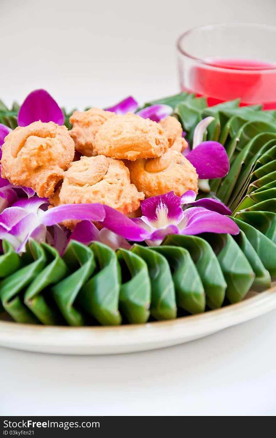 Cookie on orchid flower and banana leaf for eating