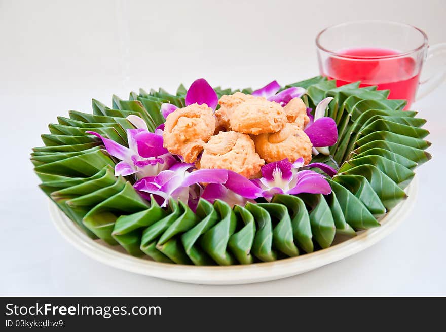 Cookie on orchid flower and banana leaf for eating