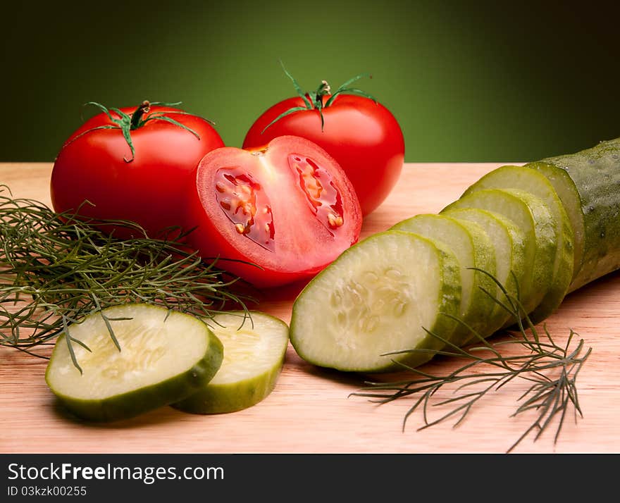 Still life of ripe tomatoes and cucumber. Still life of ripe tomatoes and cucumber