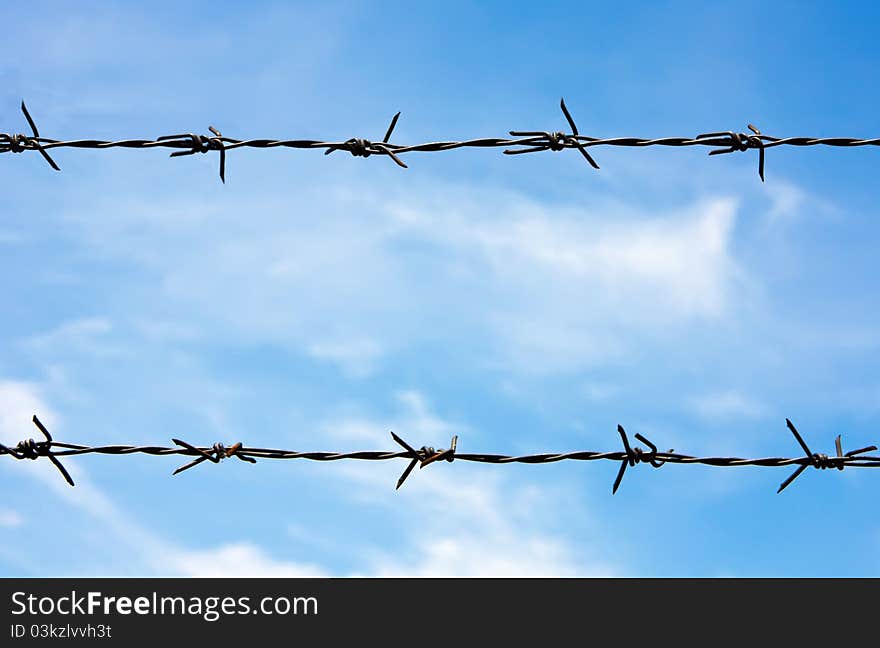 Barbed wire with blue sky