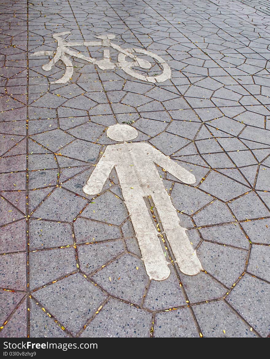 Bike and human signs on a footpath. Bike and human signs on a footpath