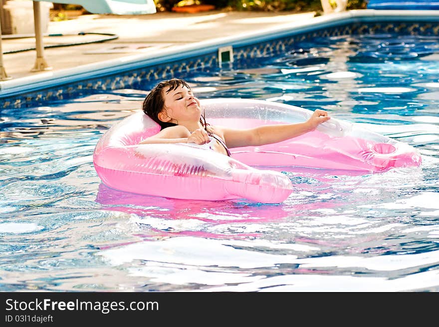 Picture of a young girl playing in a pool. Picture of a young girl playing in a pool