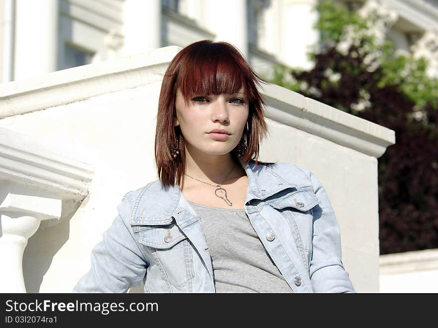 Teen girl in jacket before building [03]