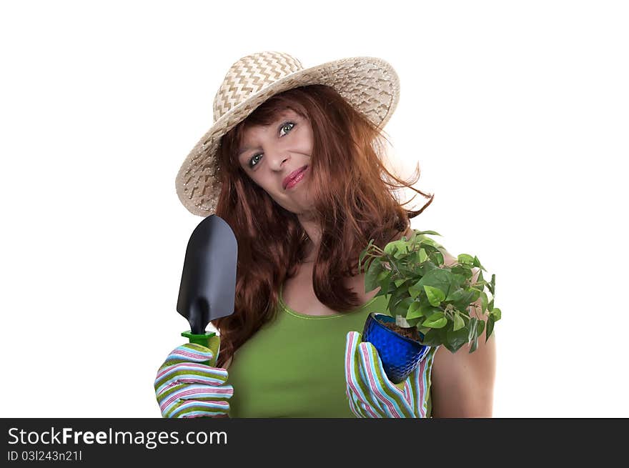 Redhead woman working in the garden with straw hat