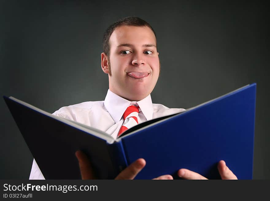 Funny guy reading blue book