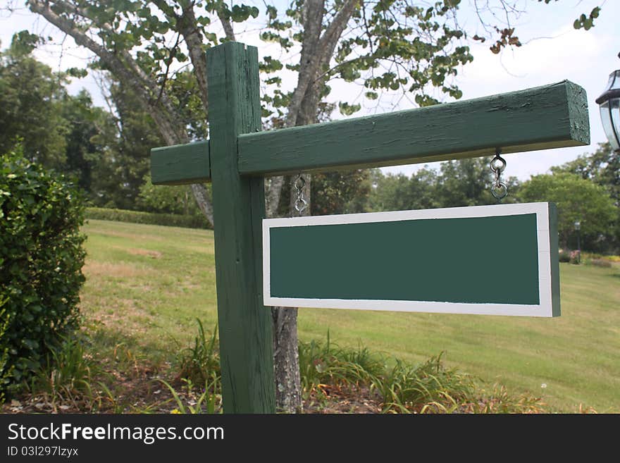 Blank sign in a beautiful rural setting. Write your own message.