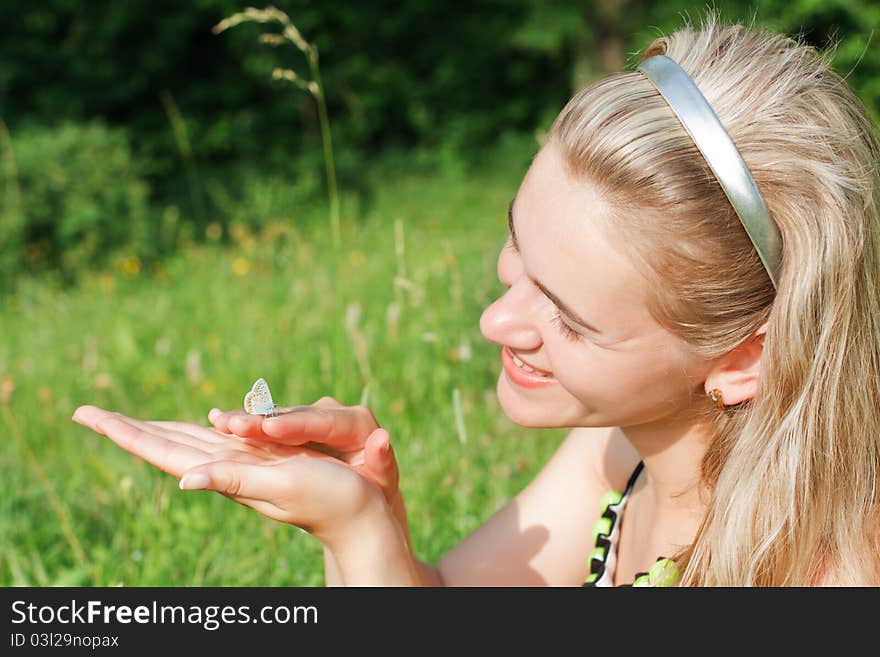 Beautiful Young Woman And Butterfly In Green Field