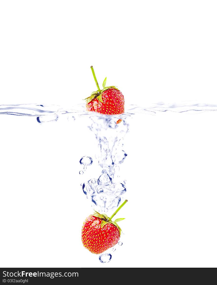 A background of bubbles forming in water after strawberries are dropped into it. A background of bubbles forming in water after strawberries are dropped into it.