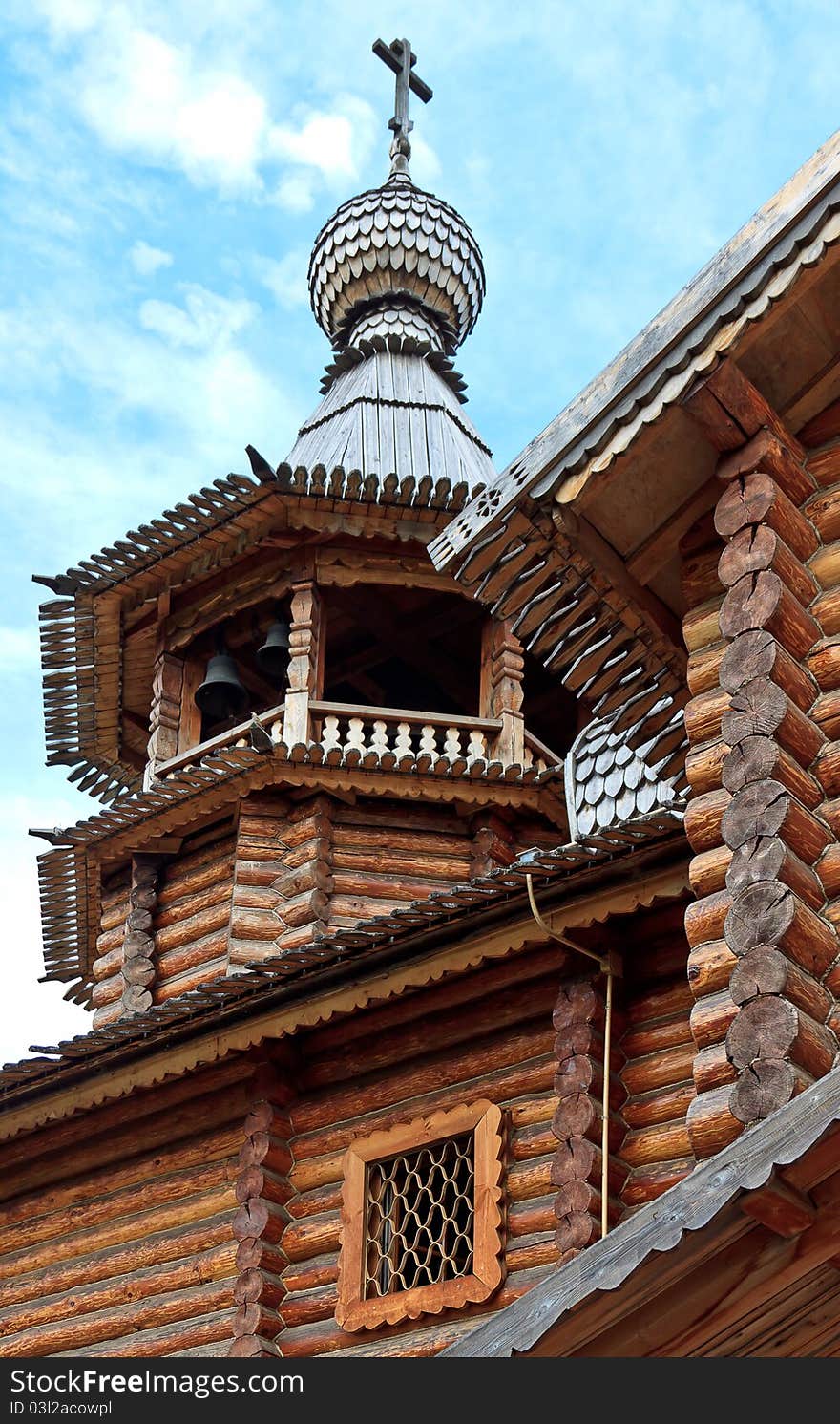 The bell tower with a dome and a cross, made in the old Russian style. The bell tower with a dome and a cross, made in the old Russian style